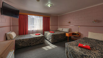 room with a double-sized bed and 2 single beds